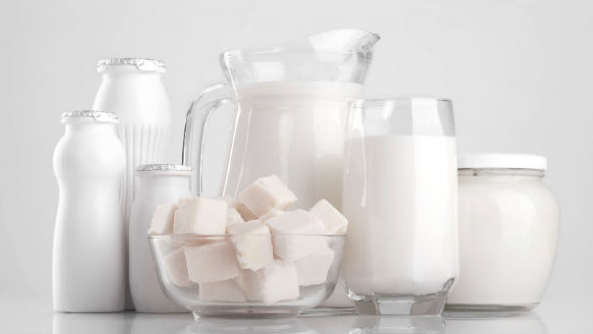 White ice cubes and glasses of milk.