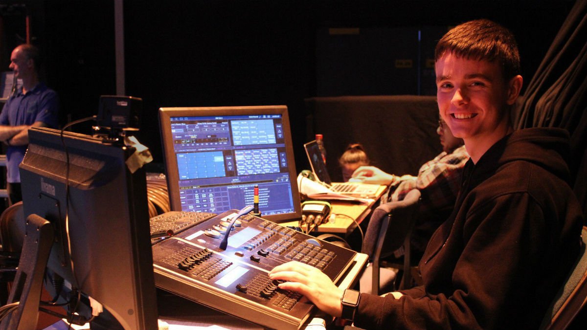 GSA student Ben Linwood sitting at a production lighting desk