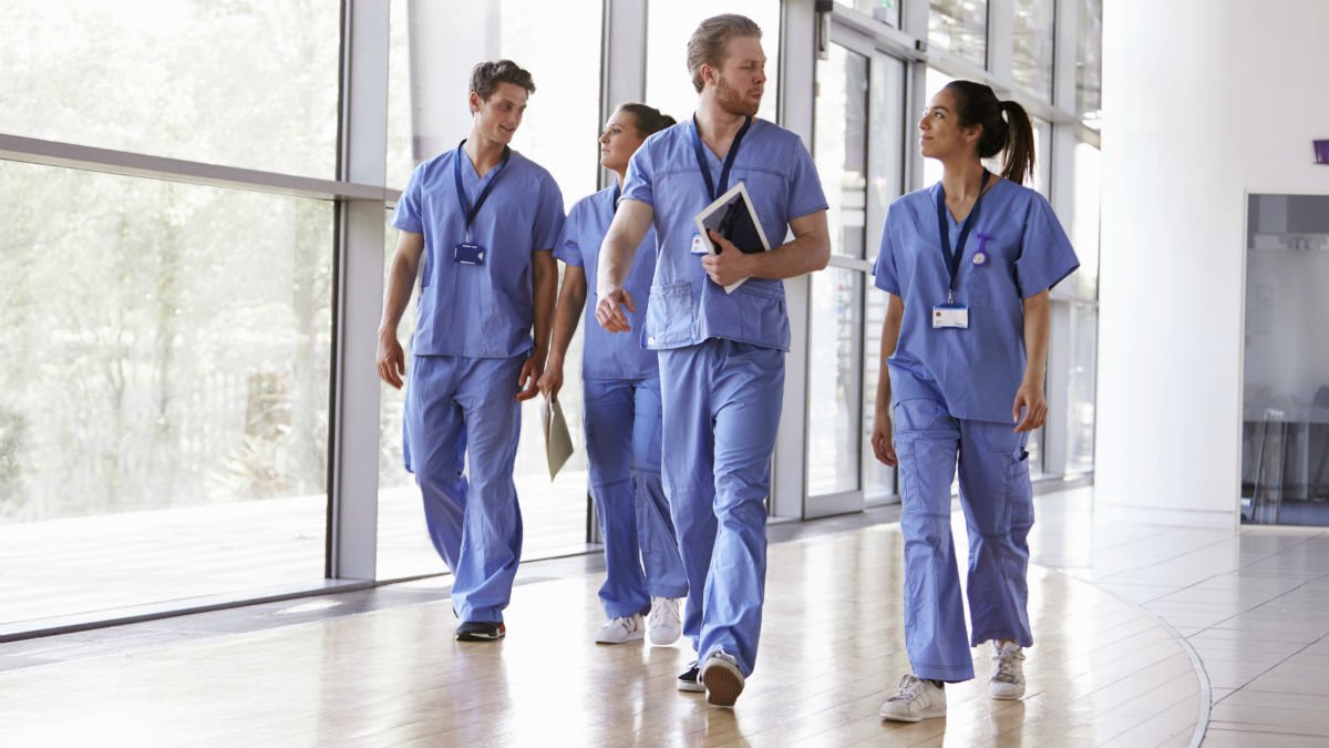 Group of doctors walking down the hallway of a hospital