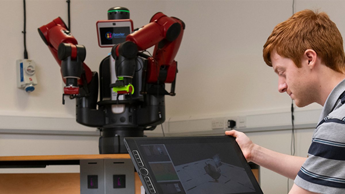 Man holding tablet that is connected to a robot