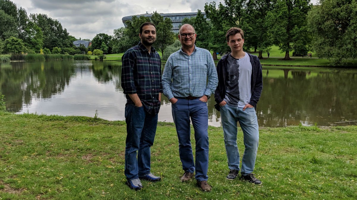 University of Surrey AI Team stood outside the Stag Hill campus lake