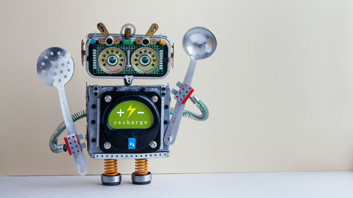 A robot chef is holding kitchen utensils