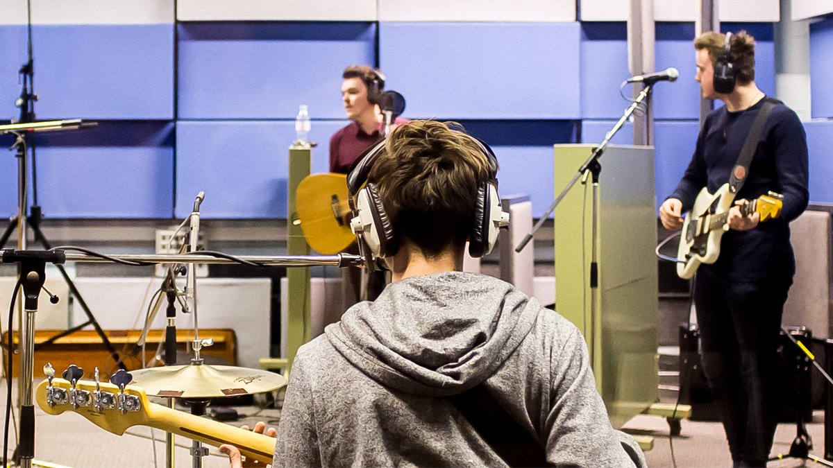 Male student playing the guitar