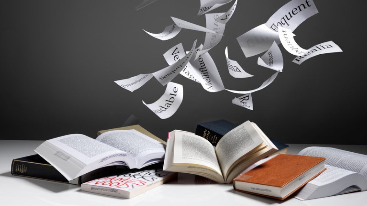 Books with words floating out of them