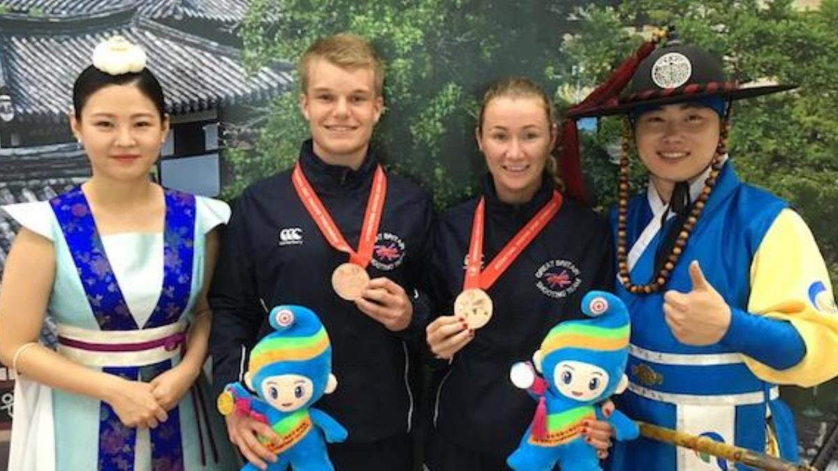 Ollie Vass with partner Rachel McManus on medal podium