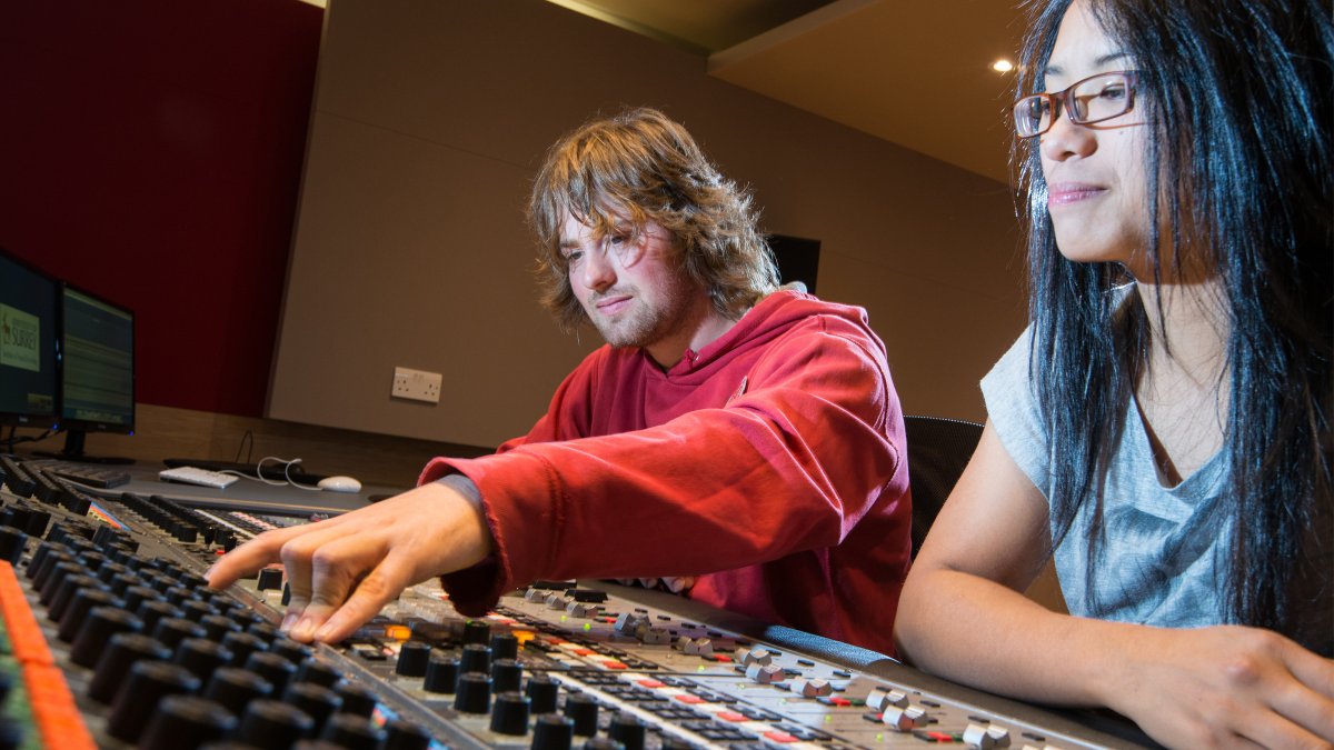 Male and female using equipment in studio 3