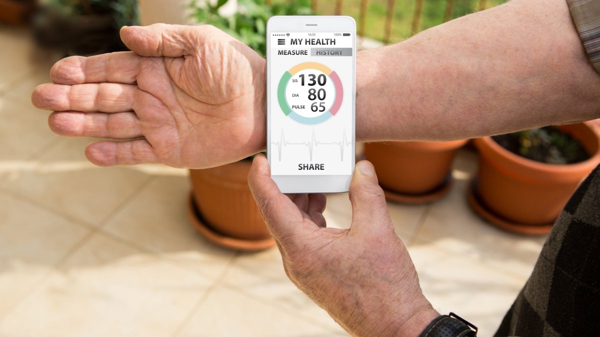 Person checking their heartbeat with tracker device