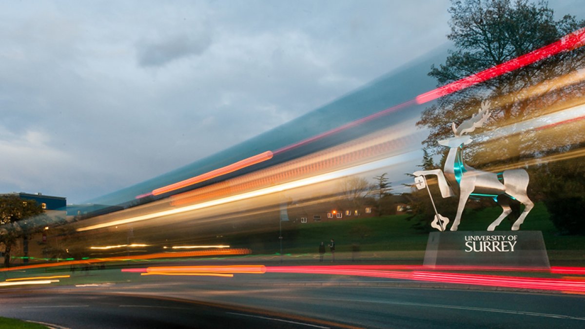 Stag sculpture in the evening with moving lights from passing traffic