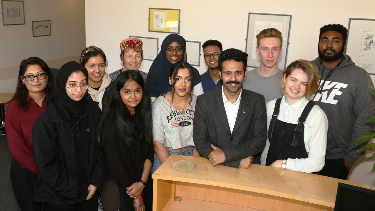 Uday with students and University staff