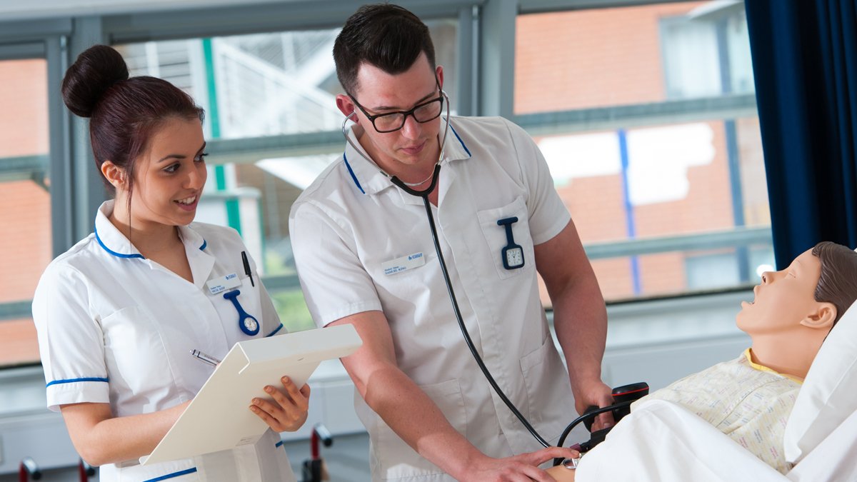 Adult nursing students working on a patient simulation