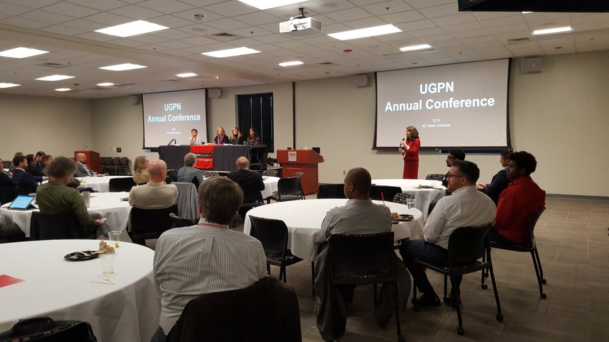 A room full of people during a talk at the April 2019 UGPN conference