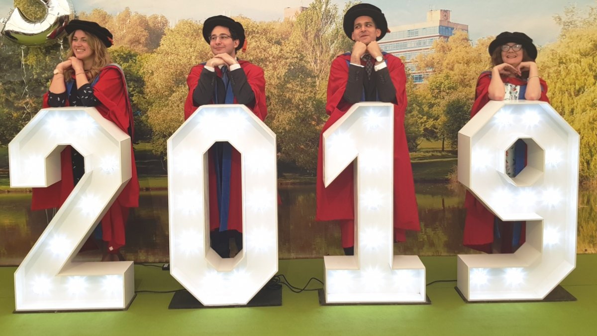 PhD graduates behind 2019 sign