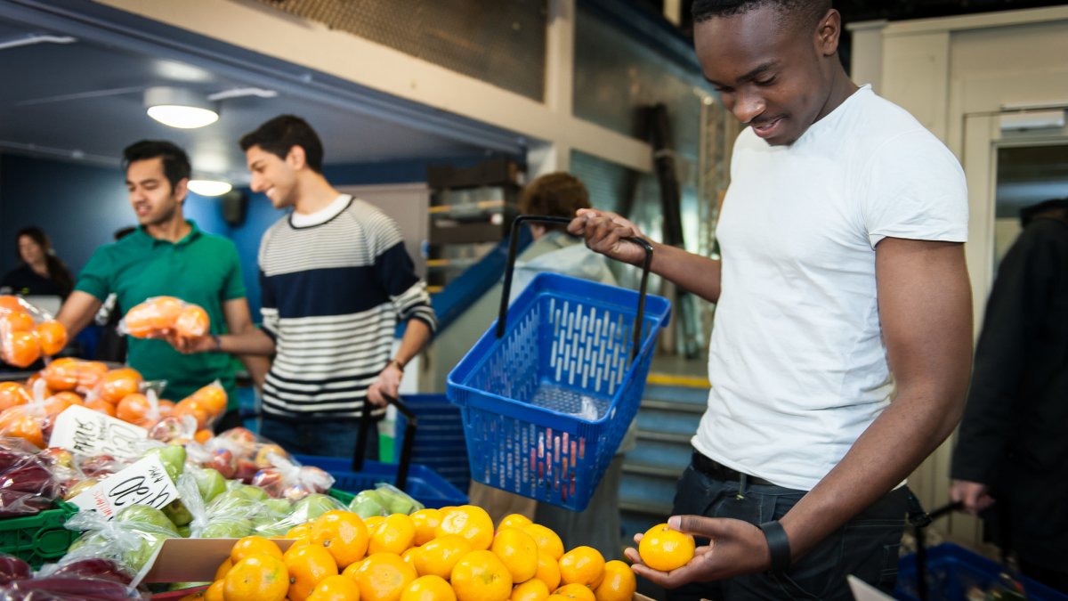 Students buying vegetables at the University of Surrey Fruit and Veg Market