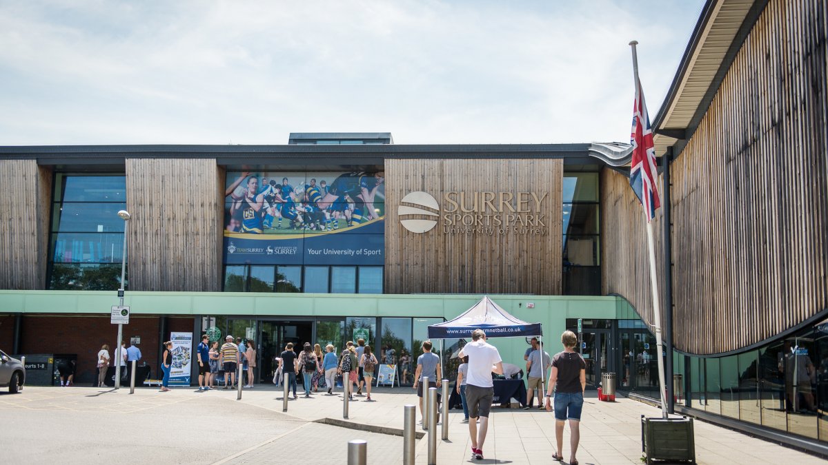 Prospective students outside Surrey Sports Park at an open day.