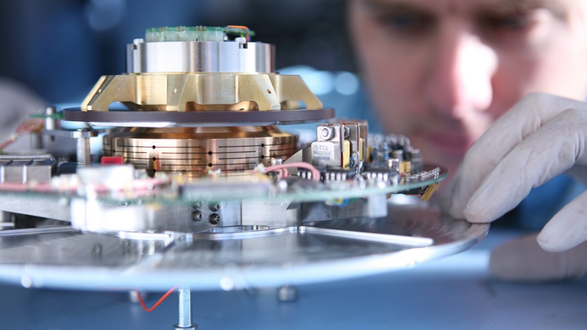 Electronic engineering student working on a piece of machinery