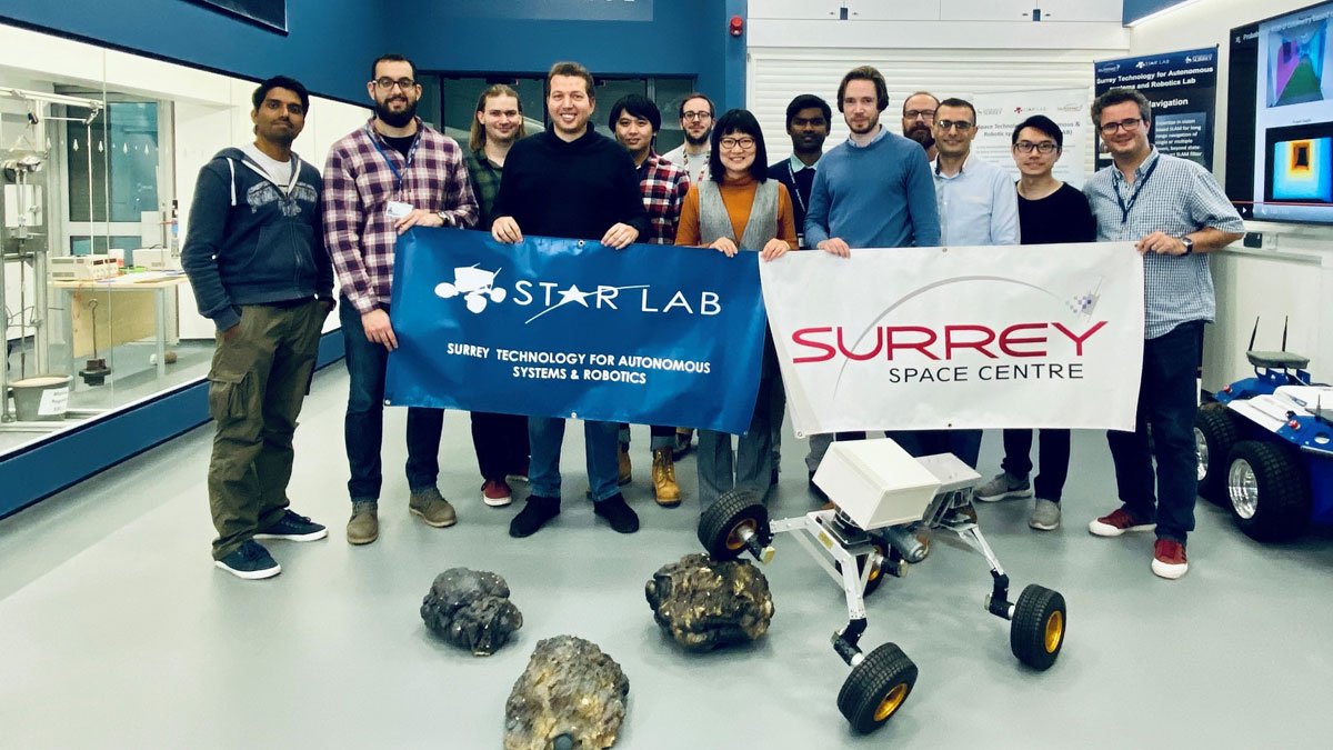 The Star Lab team holding up STAR Lab and Surrey Space Centre posters