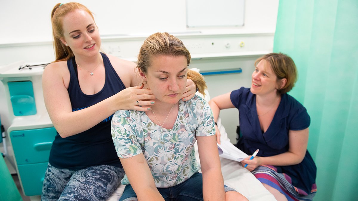 physician associate students practising their skills in the simulation suite