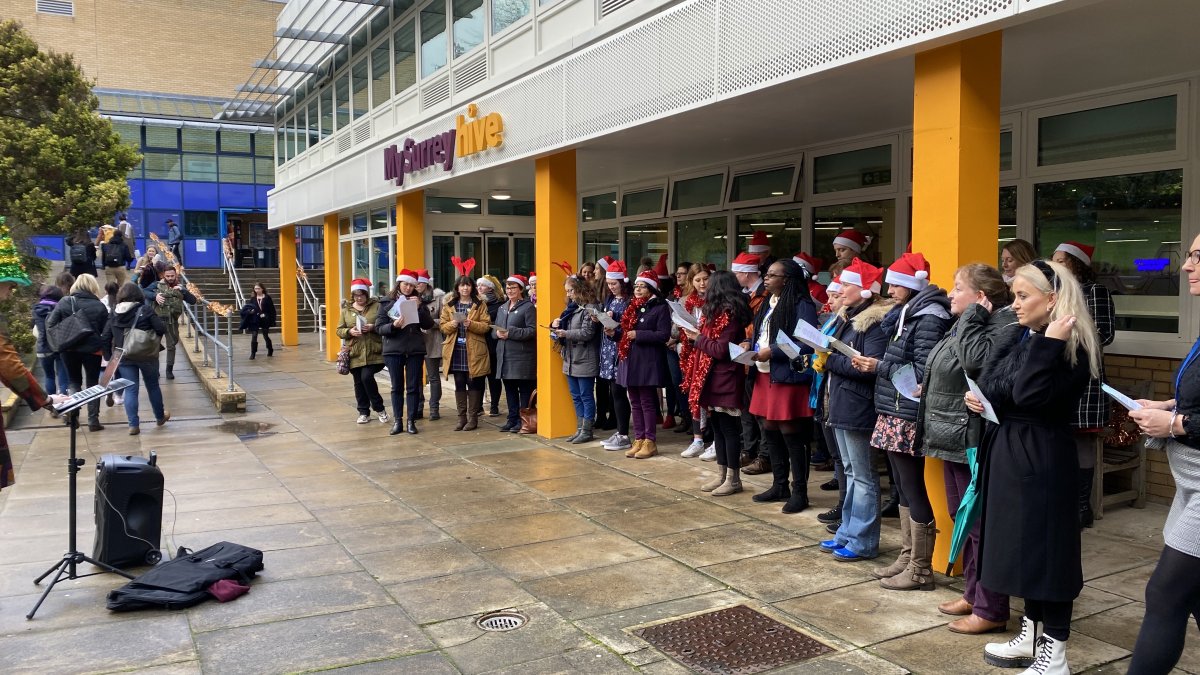 Students singing Christmas carols outside MySurrey Hive