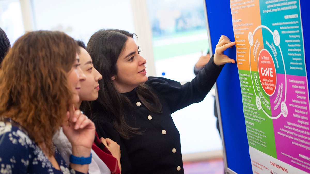 Staff looking at a poster