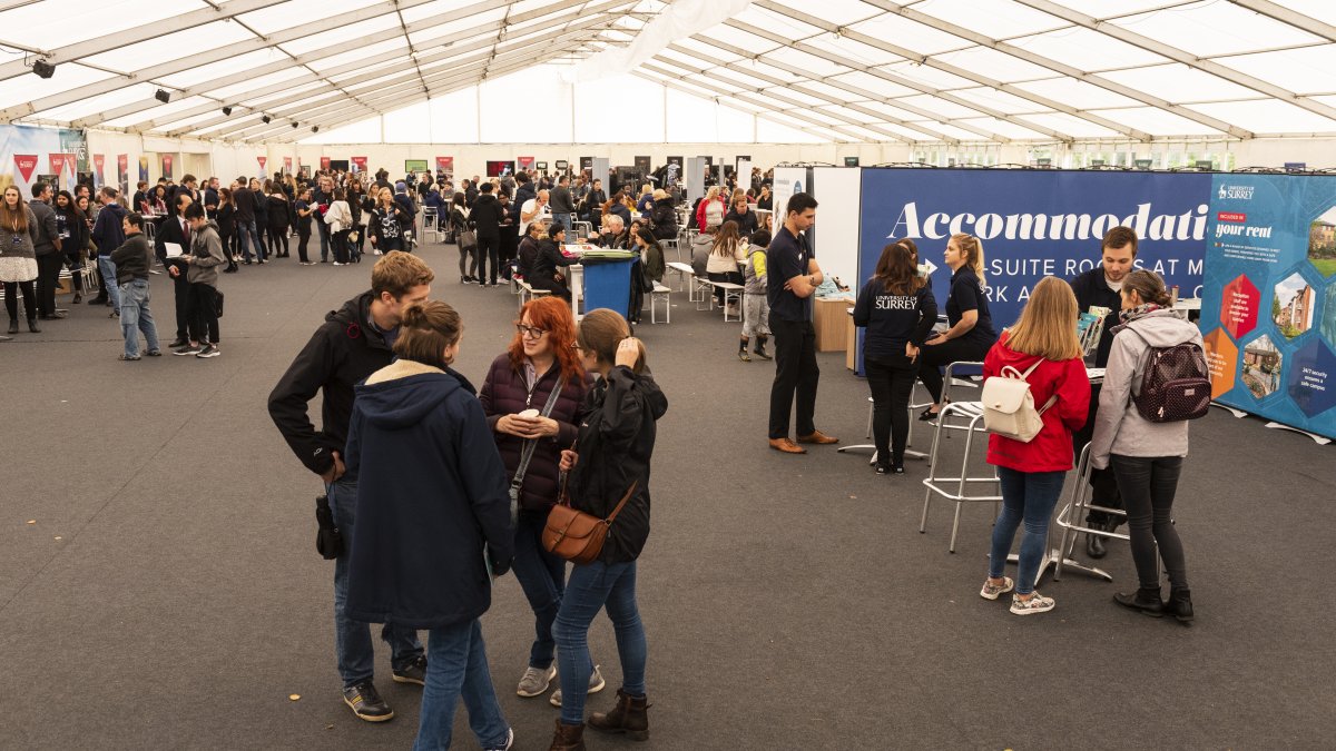 Group of students talking at the Open day marquee