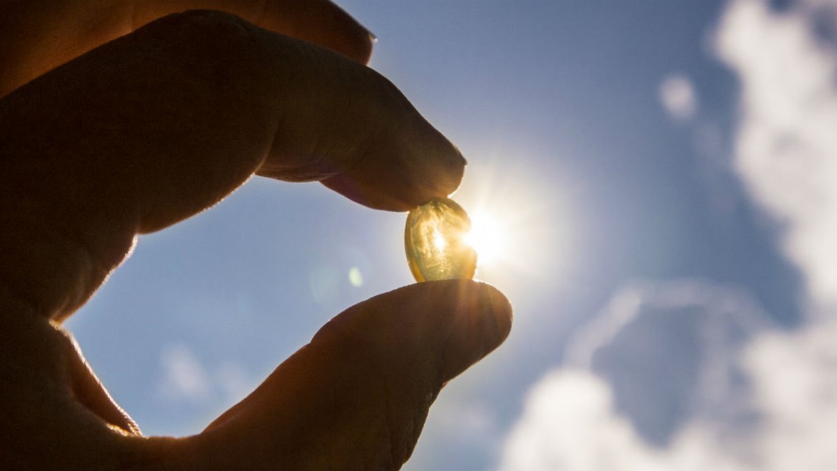 Person holding pill in their hands