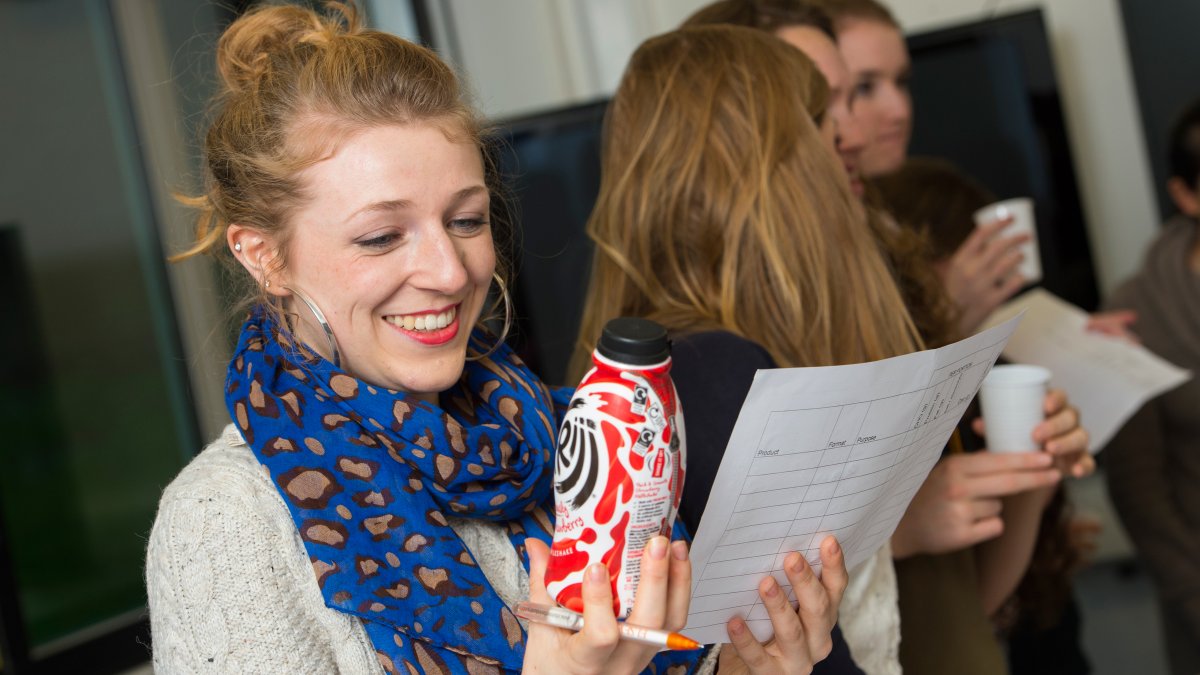 Student holding milkshake bottle