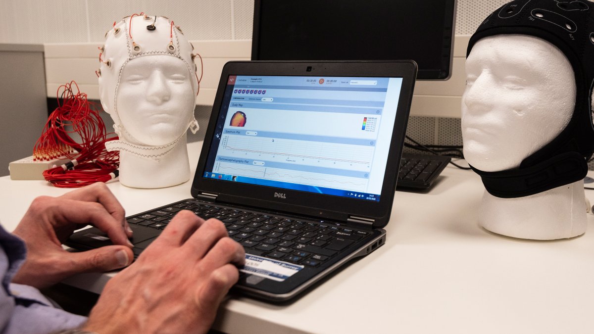 Laptop next to head monitoring equipment