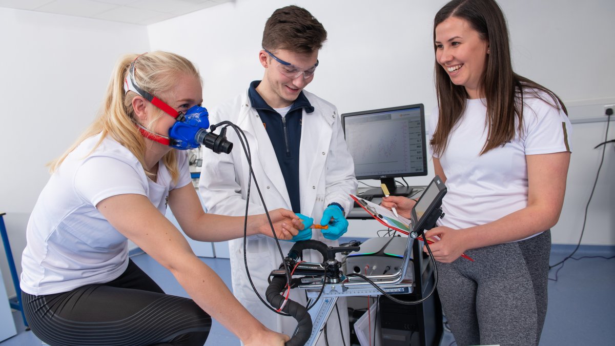 Student cycling and having their breathing monitored