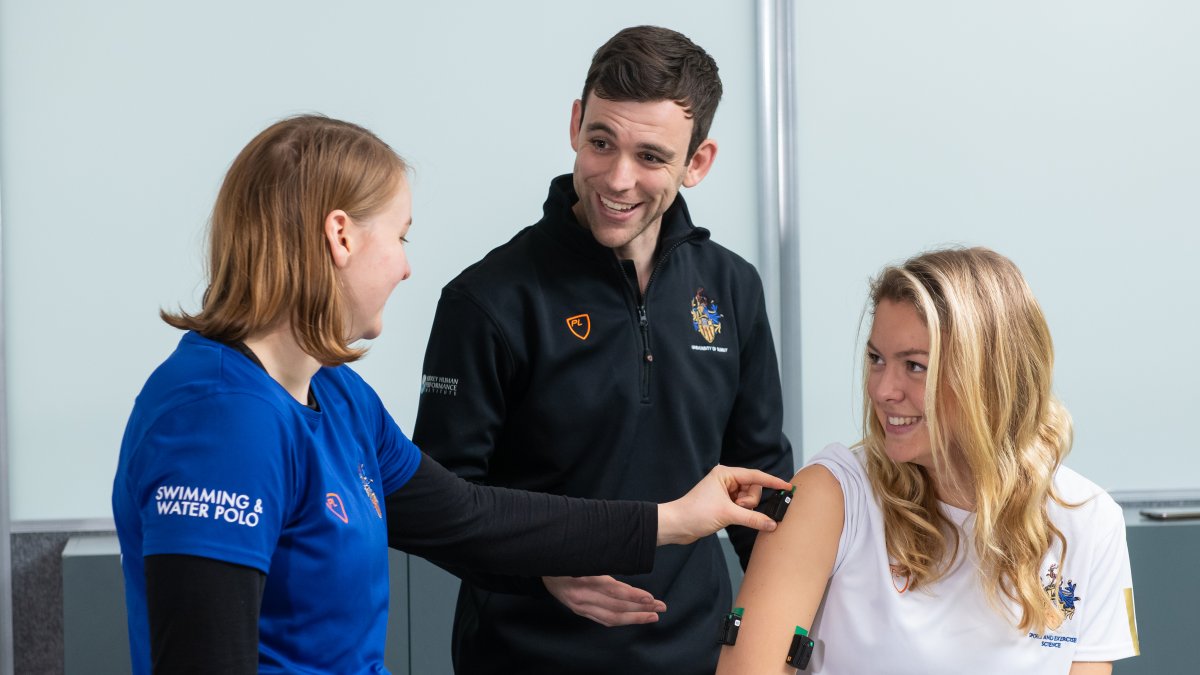 Student wearing lab equipment on arm