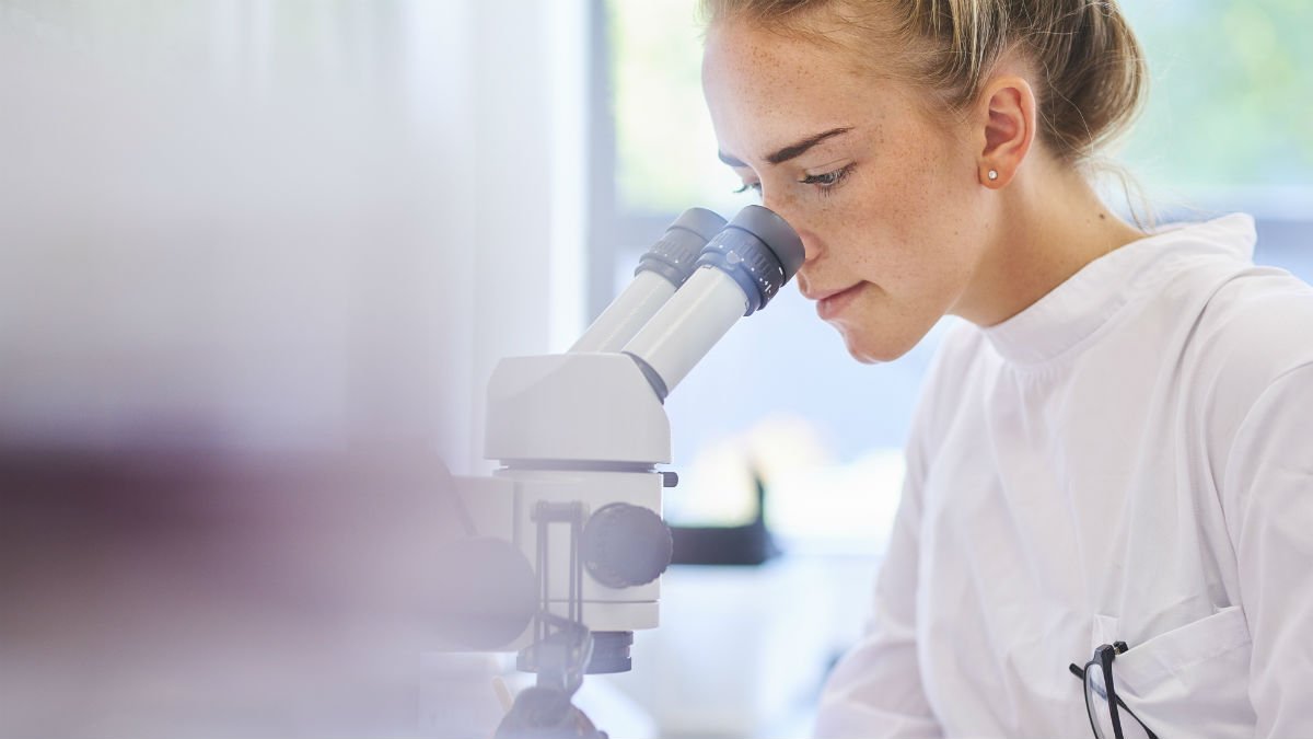 Student looking through a microscope