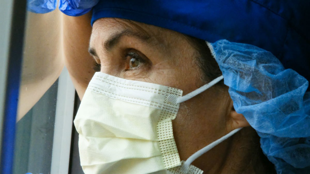 Woman wearing a mask and scrub cap