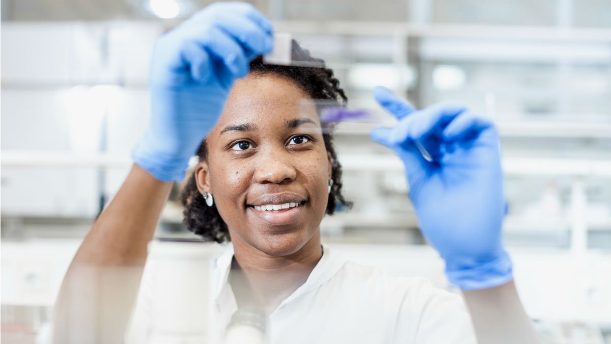 Woman holding up petri dish samples
