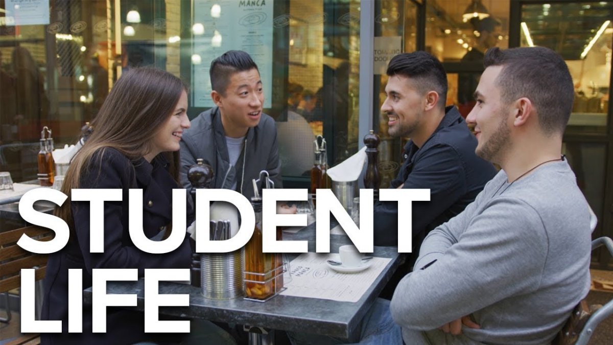 A group of students are sat round a table