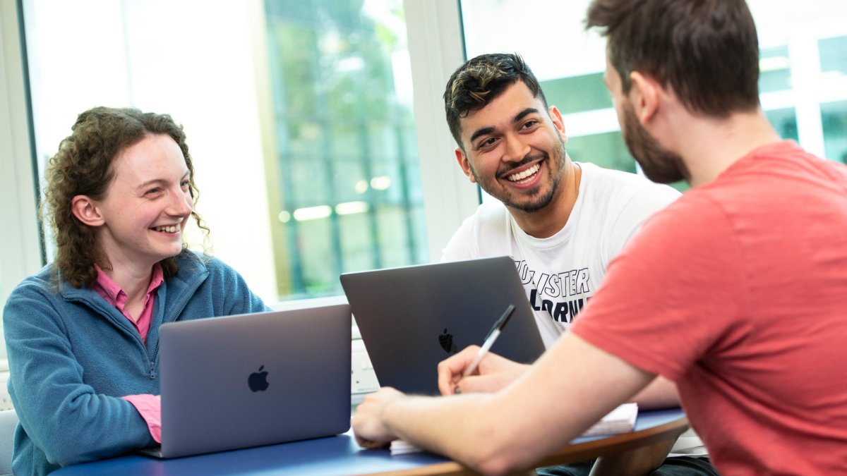 Students talking with laptop