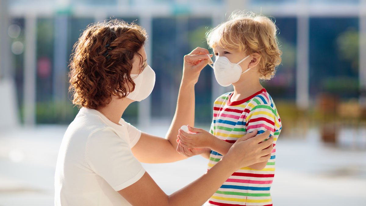 Woman and child wearing face masks