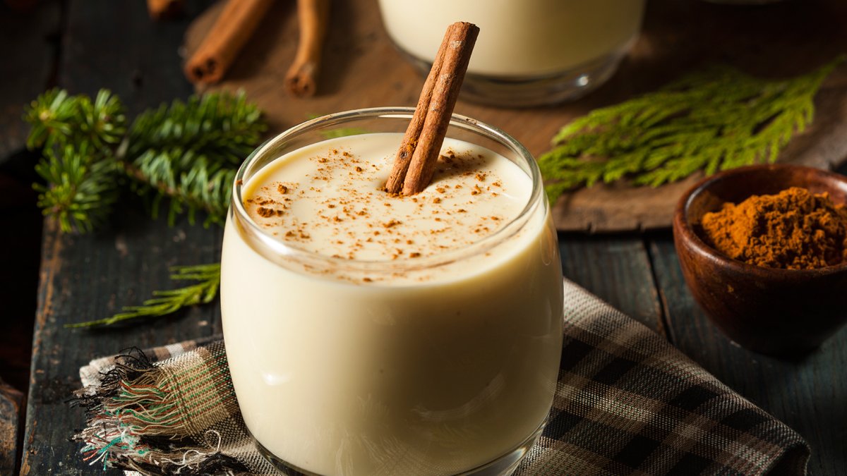 Glass of eggnog with a cinnamon stick in