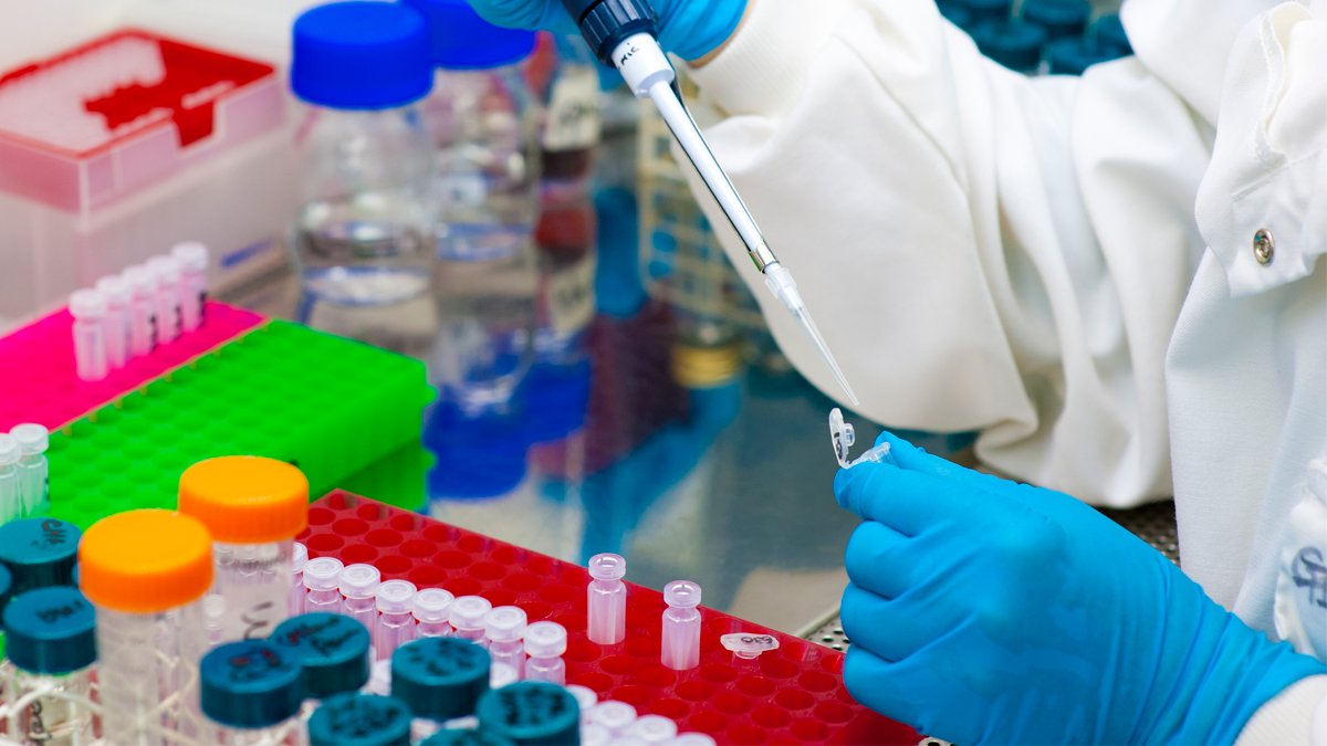 Researcher pipetting a liquid into a microcentrifuge tube