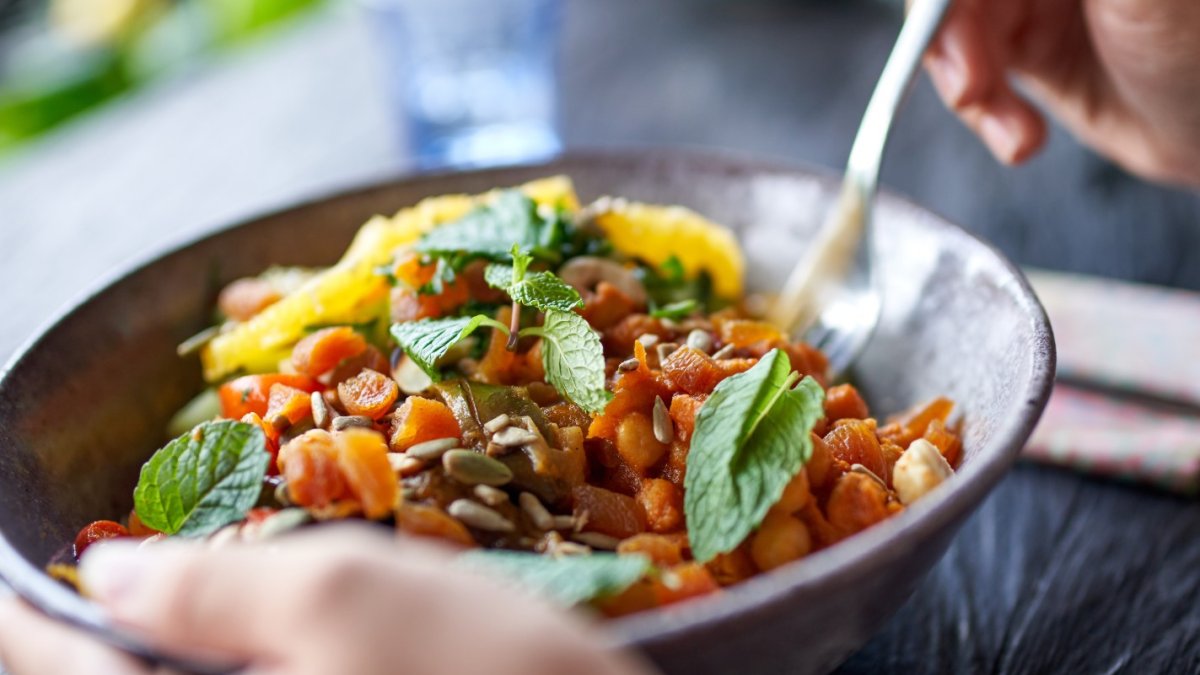 Person eating salad from a bowl