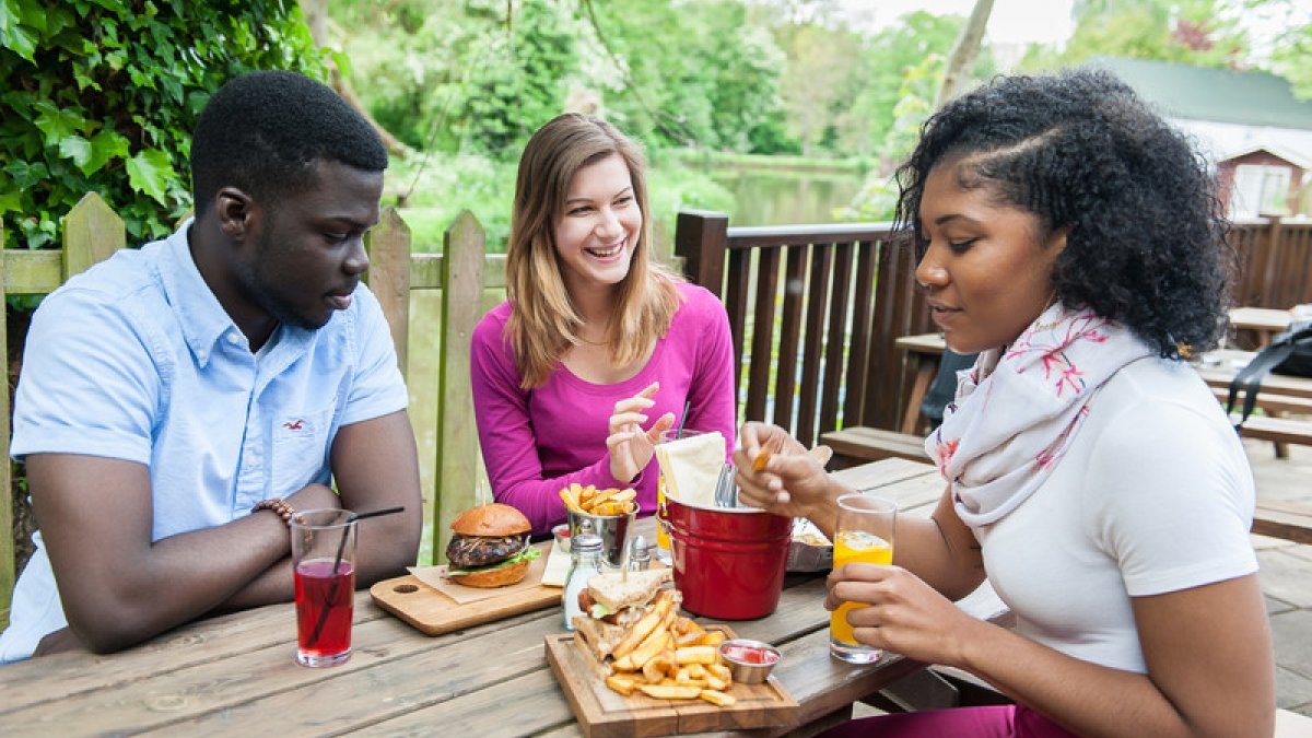 Students eating at riverside pub
