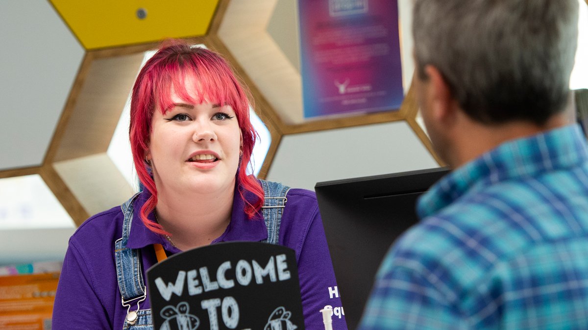 Student talking to a member of the public