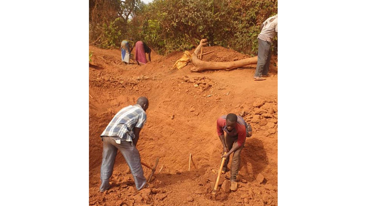 People digging with pick-axes in Africa