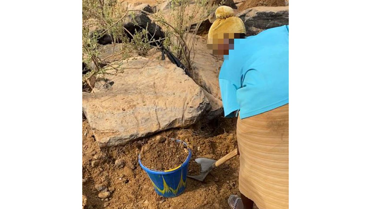 Woman collecting mud.