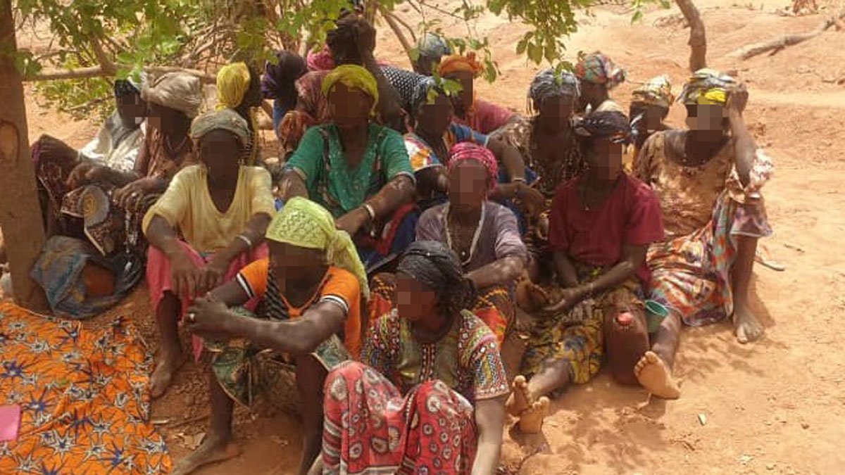 Rural community in Africa with blurred faces.