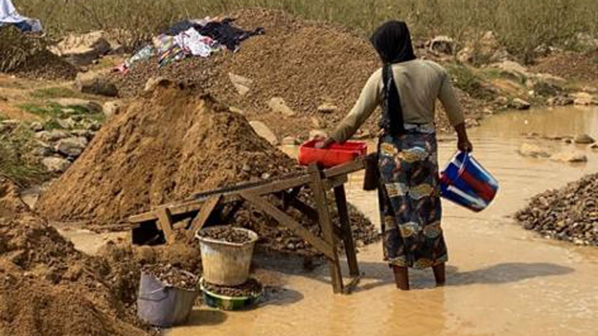 Woman collecting mud.