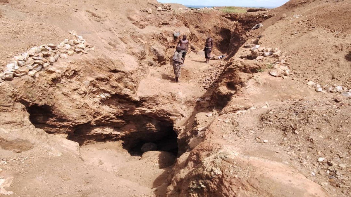 Group of men assess the mining worksite 