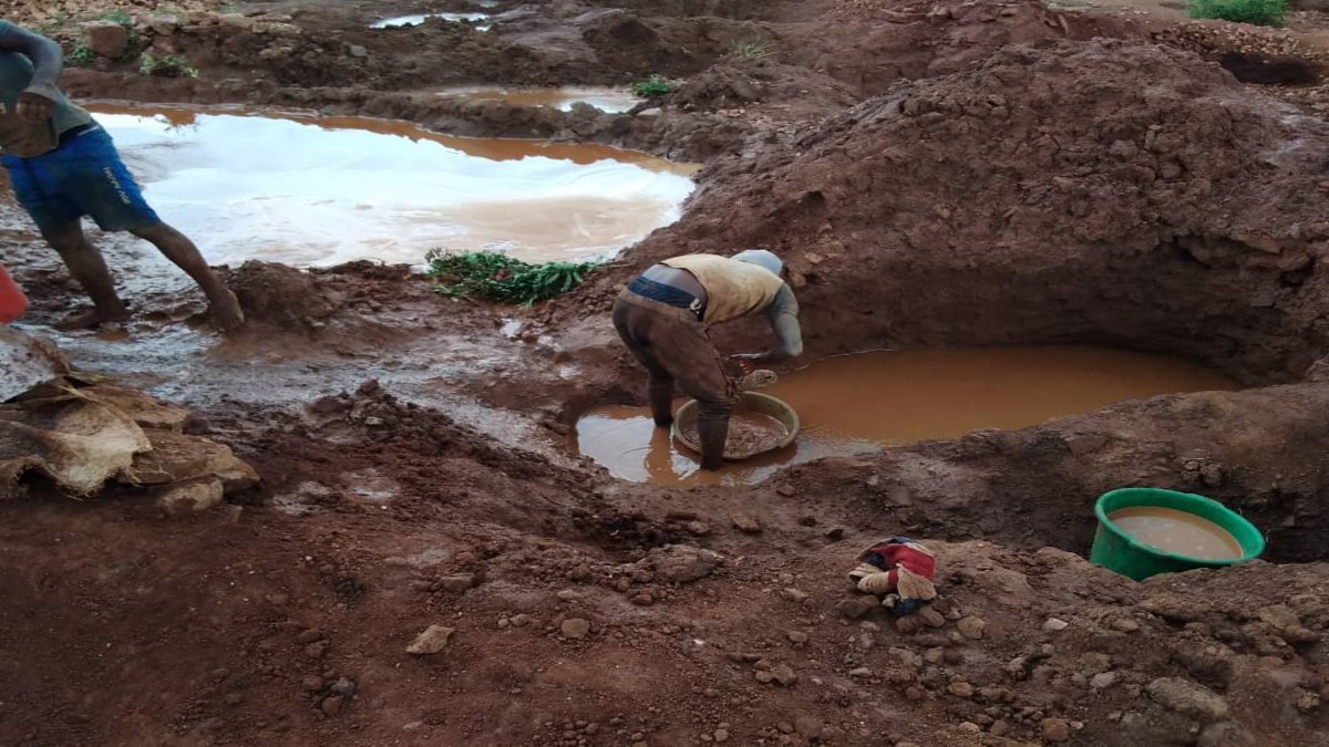 Man panning in the mud 