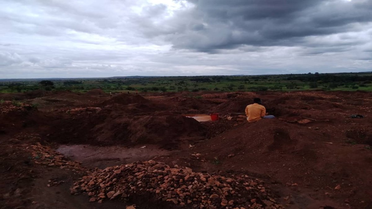 Man sits near the mining site