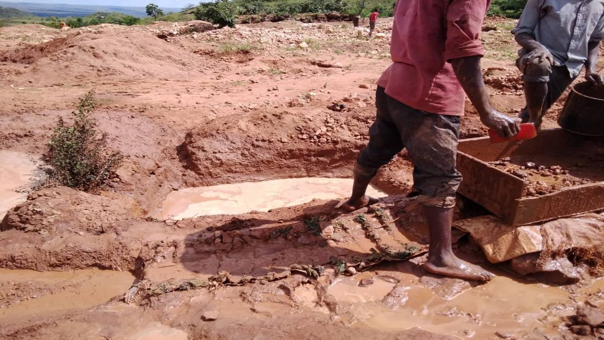 Men panning in the mud 