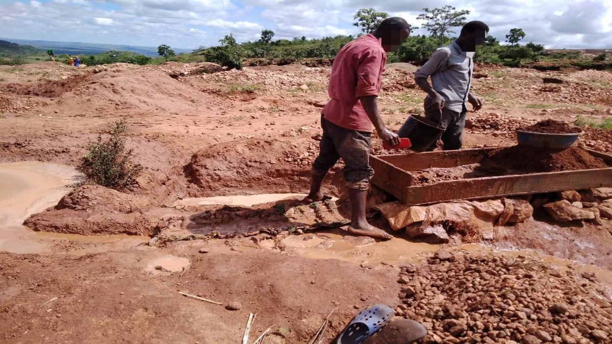 Men panning in the mud 