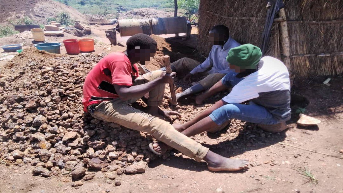 Group of men work together on the ground 